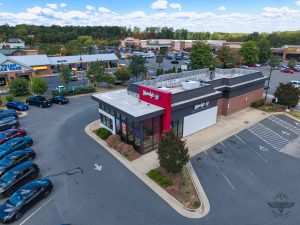 Modern Fast Food Restaurant With Busy Parking Lot