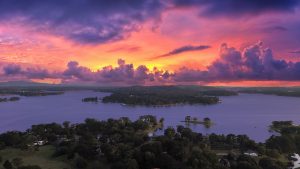 Vibrant Sunset Over Serene Lake Landscape