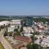 Aerial View of Modern City and Green Hills