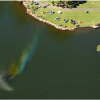 Rainbow Fountain Over Serene Park Pond
