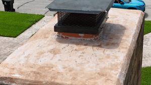 Well-Maintained Stucco Chimney With Metal Cap