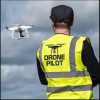 Drone Pilot Monitoring Quadcopter in Cloudy Sky