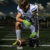 Determined Football Player Kneeling Before the Game