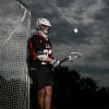 Young Lacrosse Goalie Under Stormy Skies