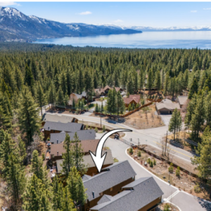 Aerial view of Lake Tahoe mountain lake residential community with pine forest homes.