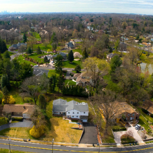 Drone Services in Philadelphia Pennsylvania showcasing suburban homes, green lawns, and city skyline.