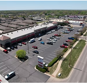Aerial view of suburban shopping center, retail plaza, and parking lot.