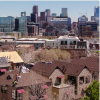 Urban Homes Beneath a Modern City Skyline