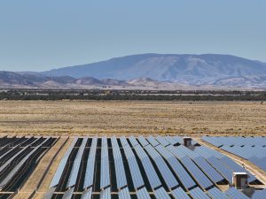 Desert Solar Farm Beneath Mountain Skies