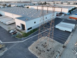 Industrial Warehouse Hub With Power Transmission Tower