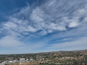 Panoramic Sky Over Rolling Hills and Town
