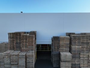Stacked Wooden Pallets Outside Warehouse Wall