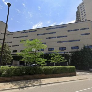Thermal inspection of 1200 Nicollet Ave modern building exterior with trees.