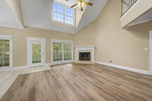 Vaulted Living Room With Fireplace and Skylight