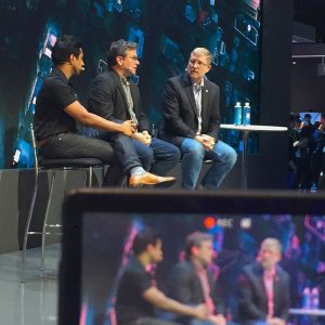 Tech panel discussion with speakers on stage at innovation conference.